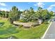 Landscaped community entrance with a decorative stone wall, lush trees, and a glimpse of the pool area at 298 Horton Grove Rd, Fort Mill, SC 29715