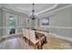 Elegant dining room with chandelier, wainscoting, and hardwood floors at 298 Horton Grove Rd, Fort Mill, SC 29715