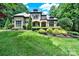 Charming stone and stucco home featuring a beautifully landscaped front yard with mature trees at 298 Horton Grove Rd, Fort Mill, SC 29715
