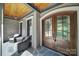 Inviting front porch with double doors, stone floor, and cozy seating at 298 Horton Grove Rd, Fort Mill, SC 29715