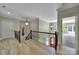 Upstairs hallway with hardwood floors, decorative railing, and chandelier lighting at 298 Horton Grove Rd, Fort Mill, SC 29715