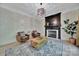 A living room with a fireplace, light wood floors, two sitting chairs, a coffee table and an area rug at 298 Horton Grove Rd, Fort Mill, SC 29715