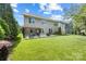 A lush backyard featuring a covered patio, mature trees and ample green space at 300 Hidden Cove Ln, Matthews, NC 28104