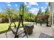 The backyard featuring a large manicured lawn, pergola with seating, and swing set at 300 Hidden Cove Ln, Matthews, NC 28104