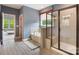 A full bathroom featuring a glass enclosed shower, soaking tub, neutral paint and tile floors at 300 Hidden Cove Ln, Matthews, NC 28104