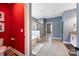 Bright bathroom showcasing a red accent wall, soaking tub, and glass-enclosed shower at 300 Hidden Cove Ln, Matthews, NC 28104
