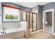 Bright bathroom with a soaking tub, separate shower, and blue accent wall at 300 Hidden Cove Ln, Matthews, NC 28104