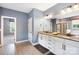 A spacious primary bathroom features a double sink vanity, granite countertops and neutral paint at 300 Hidden Cove Ln, Matthews, NC 28104
