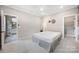 A bright bedroom featuring neutral paint, carpeted floor, ceiling fan and ensuite bathroom at 300 Hidden Cove Ln, Matthews, NC 28104