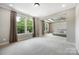 Spacious bedroom featuring tray ceiling, modern bed, and ample natural light from multiple windows at 300 Hidden Cove Ln, Matthews, NC 28104