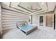 Bedroom featuring tray ceiling, fan and horizontal stripes, with ample natural light at 300 Hidden Cove Ln, Matthews, NC 28104