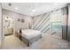 A bright bedroom features neutral paint, carpeted floor, ceiling fan and ensuite bathroom at 300 Hidden Cove Ln, Matthews, NC 28104