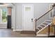 Foyer featuring a bright entryway, a staircase with wooden handrail, and an inviting entrance at 300 Hidden Cove Ln, Matthews, NC 28104