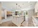 Open concept kitchen with an island seamlessly flows into the living area with a fireplace and backyard access at 300 Hidden Cove Ln, Matthews, NC 28104