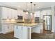 Elegant kitchen featuring an island, white cabinetry, granite countertops, and stainless steel appliances at 300 Hidden Cove Ln, Matthews, NC 28104