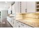 A gorgeous kitchen features custom cabinets, granite counters, tiled backsplash, and stainless appliances at 300 Hidden Cove Ln, Matthews, NC 28104