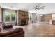 Open living room with stone fireplace, hardwood floors and sliding glass doors at 300 Hidden Cove Ln, Matthews, NC 28104