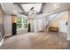 Inviting living room with tray ceiling, large windows, and hardwood floors, perfect for Gathering gatherings at 300 Hidden Cove Ln, Matthews, NC 28104