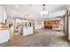 Spacious open floorplan integrating a modern kitchen with a cozy living area and rustic wood accent wall at 300 Hidden Cove Ln, Matthews, NC 28104