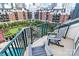 Inviting balcony space with comfortable chairs overlooking a serene courtyard with lush greenery and a pool at 300 W 5Th St # 644, Charlotte, NC 28202