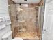 Spacious shower with glass door, and stone tiles, complemented by modern fixtures and a convenient shower niche at 300 W 5Th St # 644, Charlotte, NC 28202