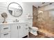 Updated bathroom with shiplap accent wall, modern vanity, and glass-enclosed shower featuring elegant tile work at 300 W 5Th St # 644, Charlotte, NC 28202