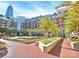 Well-manicured courtyard, featuring lush greenery, red brick, and a stunning building in the background at 300 W 5Th St # 644, Charlotte, NC 28202