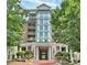 Exterior shot of an entryway framed by mature trees and landscaping, pillars, and covered entrance at 300 W 5Th St # 644, Charlotte, NC 28202