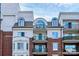 Beautiful condo building with arched windows, balconies, and brick accents against a cloudy sky at 300 W 5Th St # 644, Charlotte, NC 28202