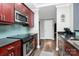 Cherry wood cabinets paired with stainless steel appliances and hardware and leading into the hallway at 300 W 5Th St # 644, Charlotte, NC 28202