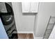 Efficient laundry room equipped with a modern washer and dryer and convenient shelving at 300 W 5Th St # 644, Charlotte, NC 28202