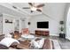 Bright living room featuring a ceiling fan, TV, and a comfortable leather sofa with decorative pillows at 300 W 5Th St # 644, Charlotte, NC 28202