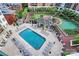 Aerial view of a refreshing outdoor pool area surrounded by lounge chairs, tables, and well-manicured landscaping at 300 W 5Th St # 644, Charlotte, NC 28202