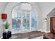 Arched window with blinds, offering a bright view and natural light into the living area at 300 W 5Th St # 644, Charlotte, NC 28202