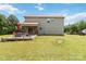Backyard view of the home, a wooden deck, outdoor seating, and grassy lawn at 3401 Shillinglaw Rd, Sharon, SC 29742