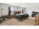 Spacious bedroom with carpet flooring, two windows, and a wooden headboard; creating a warm, inviting atmosphere at 3401 Shillinglaw Rd, Sharon, SC 29742