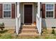 Front porch features brick steps, white railings, and lantern decorations at 3401 Shillinglaw Rd, Sharon, SC 29742