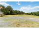 Large front yard with a gravel driveway, expansive grassy lawn, and mature trees at 3401 Shillinglaw Rd, Sharon, SC 29742