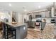 Open kitchen featuring stainless steel appliances, gray cabinets, and a granite-topped island with bar stool seating at 3401 Shillinglaw Rd, Sharon, SC 29742