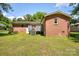 Brick home featuring a spacious backyard and a wooden deck, perfect for entertaining at 3455 Hickory Pl, Salisbury, NC 28144