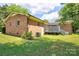 Brick home featuring a spacious backyard and a wooden deck, perfect for entertaining at 3455 Hickory Pl, Salisbury, NC 28144