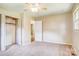A bright bedroom featuring soft carpet, a ceiling fan, closet and entry doors at 3455 Hickory Pl, Salisbury, NC 28144