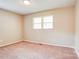 Neutral bedroom with carpet, a window, and ample wall space for decor at 3455 Hickory Pl, Salisbury, NC 28144