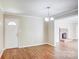 Open dining area with wood floors, fireplace view, and a white front door at 3455 Hickory Pl, Salisbury, NC 28144
