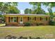 Charming brick home with a well-manicured front lawn and classic black shutters at 3455 Hickory Pl, Salisbury, NC 28144