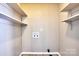 Bright laundry room with upper storage shelves and hookups at 3455 Hickory Pl, Salisbury, NC 28144