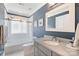 Modern bathroom with blue walls, tiled shower, and sleek vanity with light countertop at 423 State St, Charlotte, NC 28208