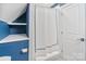 Cozy shower with white curtain, built-in shelves, and light tiles at 423 State St, Charlotte, NC 28208