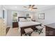 Comfortable bedroom with dark wood furniture, ceiling fan, and natural light from two windows at 423 State St, Charlotte, NC 28208