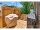 Outdoor deck with wood flooring, wood fence and features two barbecue grills with covers at 423 State St, Charlotte, NC 28208